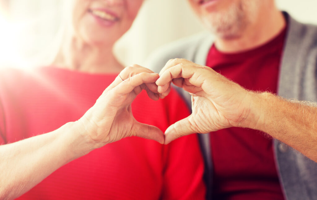 Couple making a heart shape with their hands